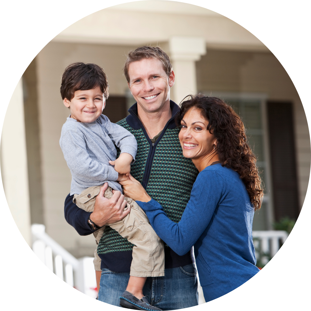 Happy family with Dad holding their child and mother embracing the husband.